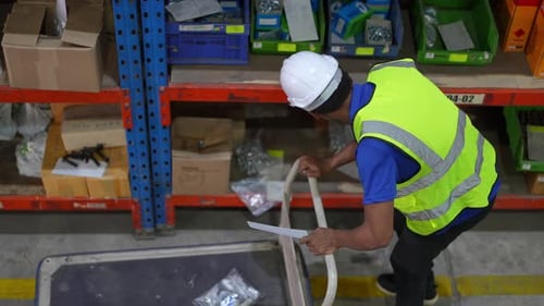 Worker Doing Inventory in Warehouse. Dispatcher in uniform making inventory in storehouse. supply ch