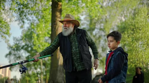 Elderly Caucasian Man Fishing with Grandson Spending Weekend Near River Grandparent Teaching His