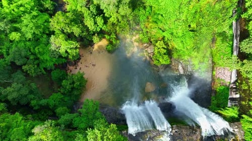 Aerial view over a waterfall in a beautiful tropical forest.