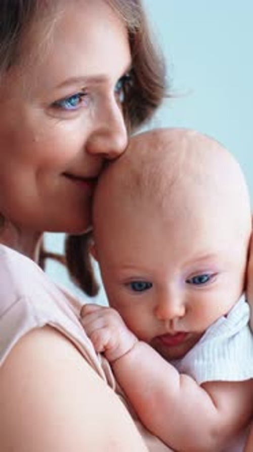 A Mother Tenderly Cradles Her Baby in a Peaceful Heartwarming Moment at Home Surrounded By the