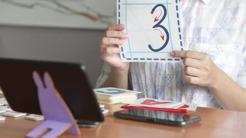 Woman Showing How to Draw the Number Three