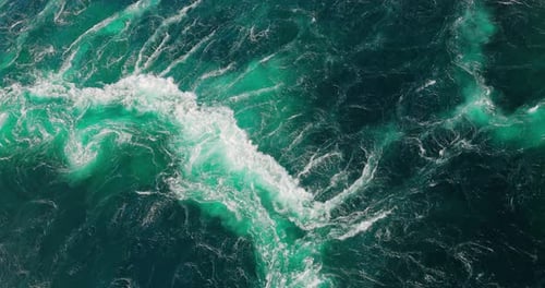 Blue waves of water of the river and the sea meet each other during high tide and low tide.