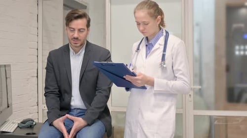 Female Doctor Writing Information while Listening Patient in Clinic