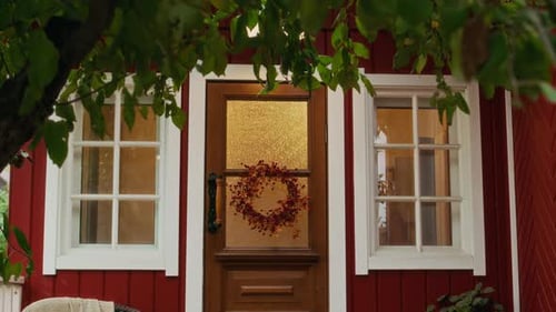 Red House with Autumn Wreath and Cozy Ambiance