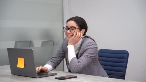 Young Woman Working at Computer in Modern Office