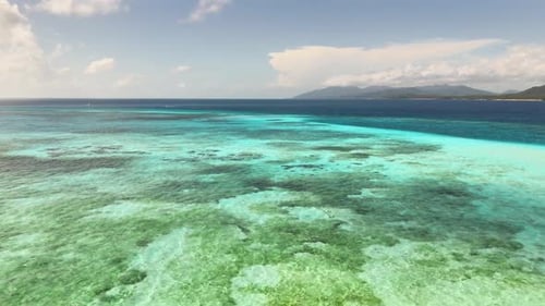 Expansive coral shallows and turquoise sea near Candaraman Sand Bar, Balabac, Palawan, Philippines.