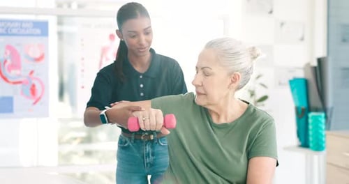 Senior Woman Lifts Dumbbell with Assistance