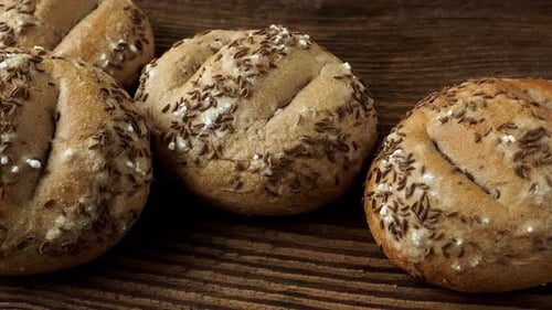 Bread rolls sprinkled with salt and caraway. Bakery assortment of bread.