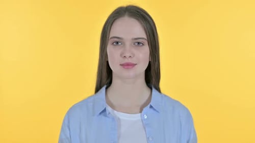 Young Woman Portrait Against Yellow Background