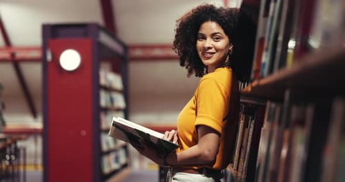 Happy woman, face and student with book in library for knowledge or literature in bookstore