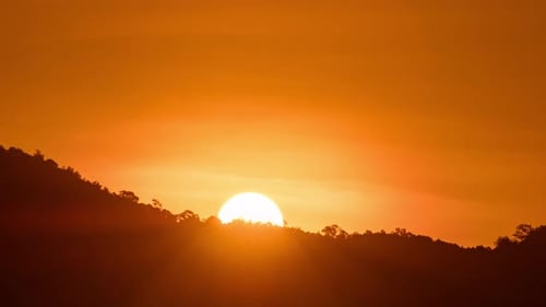 Breathtaking beauty of the sun rising time lapse video over a rugged mountain ridge.