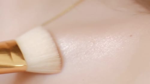 Close Up View of Female Makeup Artist s Hand Highlighting with a Highlighter Model s Pretty
