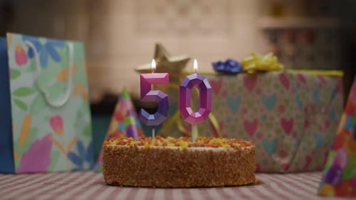 Number 50 Candle on Birthday Cake with Gifts 50Th Anniversary