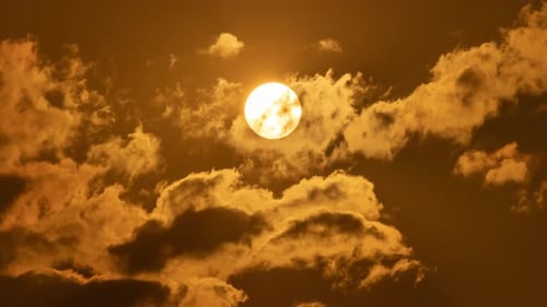 Timelapse of dramatic sunset with orange sky in a sunny day.