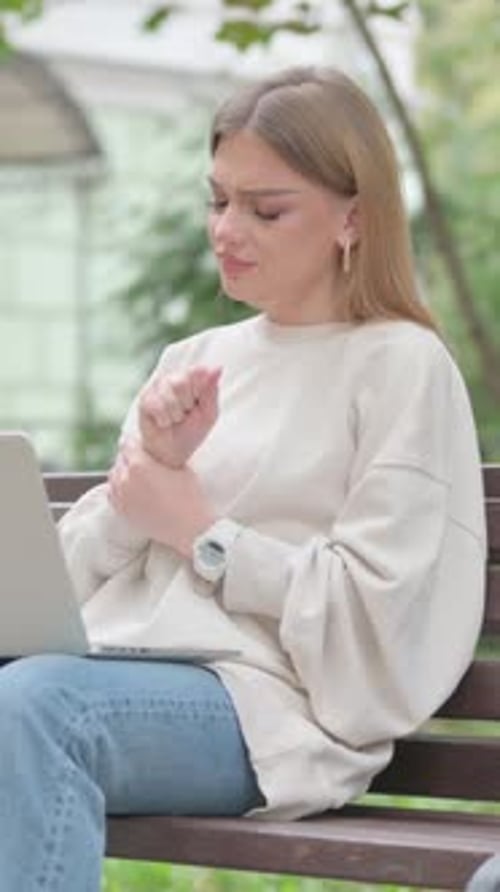 Woman Typing on Laptop on Park Bench