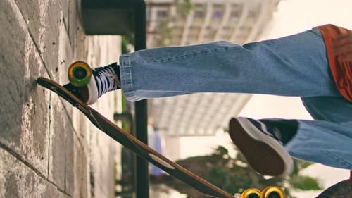 Boy Training Trick Skateboard on Street Vertical Skateboarder Balance on Wheel