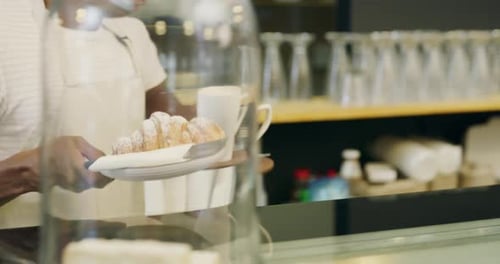 4k video footage of an unrecognizable man serving a customer in a bakery