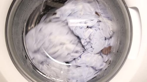 Clothes Being Washed in a Washing Machine