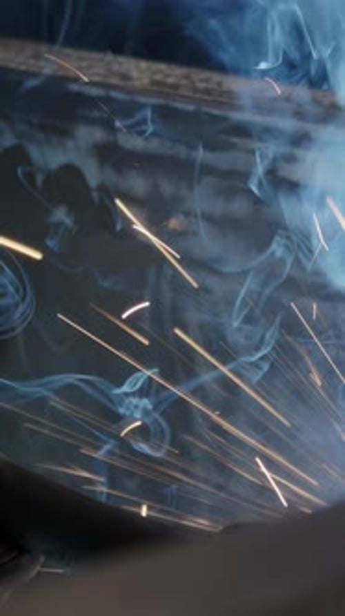 A Close Up Examination of the Welding Process Featuring Sparks and Radiant Blue Light Stock Clip