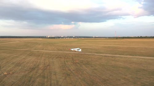 Small Airplane Takes Off From Grass Airstrip of Small Airport