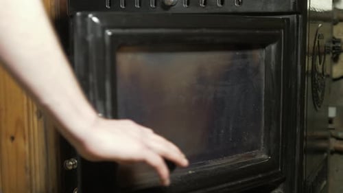 Adding coal to household back boiler stove