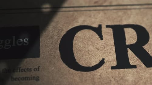 Close up pan Crisis Headline of old retro newspaper in editorial office