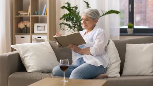 Senior Woman Relaxing at Home, Writing in Journal