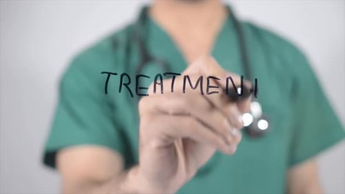 Doctor Writes Treatment on Clear Surface Close Up