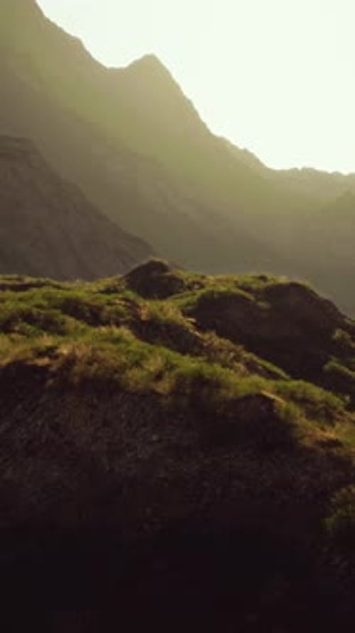 The Sun Shines Through the Mountains on a Sunny Day