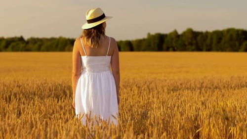 Nature and People Concept - Young Woman in Straw Hat and White