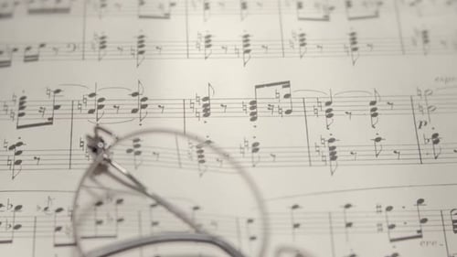 View over musical notes and glasses