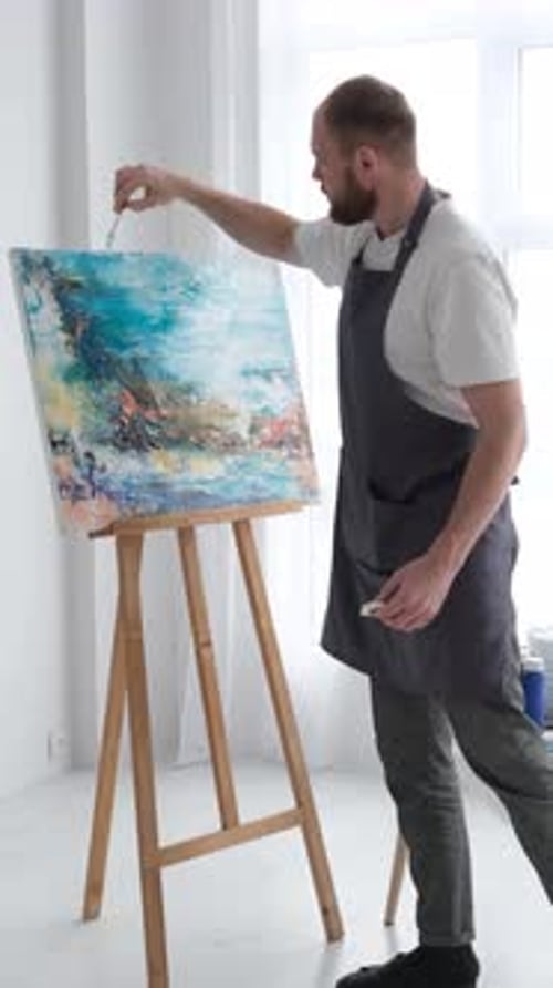 Man Painting an Abstract Art Piece on Canvas