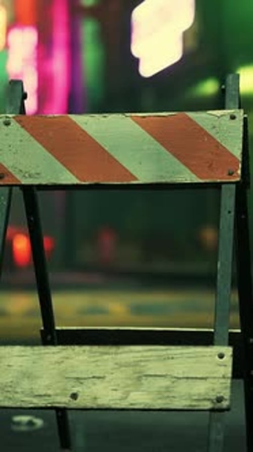 A Wooden Sign Sitting on the Side of a Road