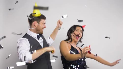 Couple Celebrating with Party Blowers and Confetti
