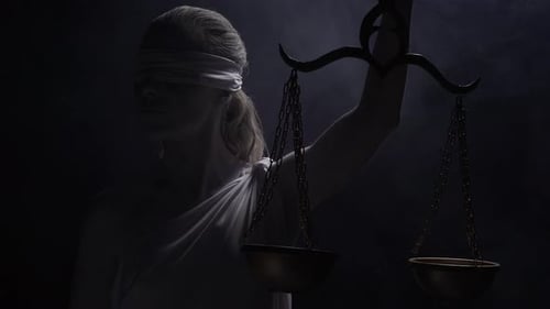 Symbol of Justice with Scales in Dark Setting