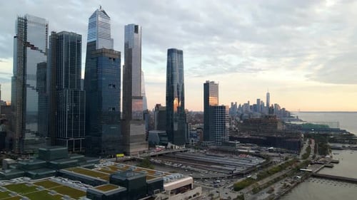 Aerial view of the New York City waterfront skyline, buildings in Hudson Yards, the river, sunset an
