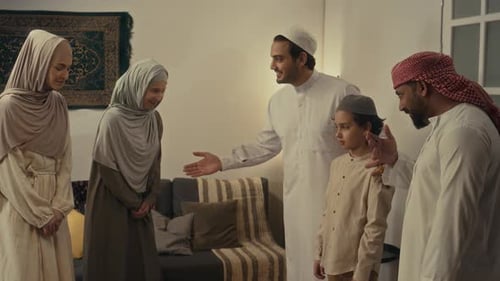 Muslim Introducing Young Covered Sisters to His Friend at Home