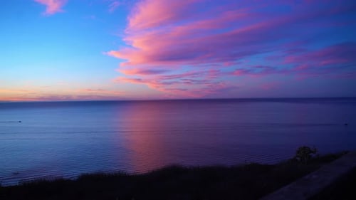pink clouds over the ocean at sunrise