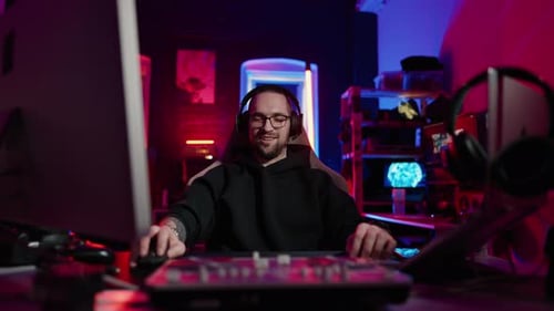 Man Gaming in Room with RGB Lighting
