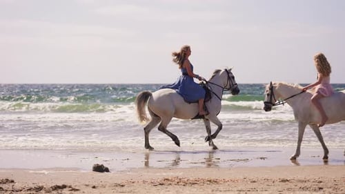 Girls Riding White Horses At The Beach