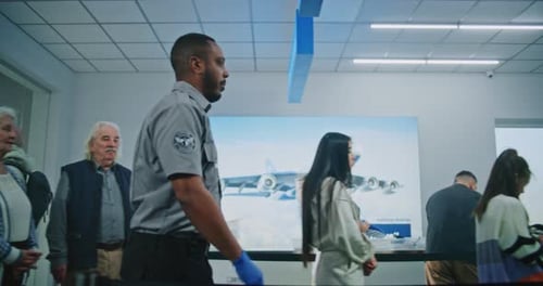 Queue of Tourists Waiting for TSA Screening Procedures Security Officers Checking Passengers