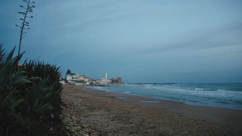Lighthouse Flashing in Night in Punta Secca Sicily Coast