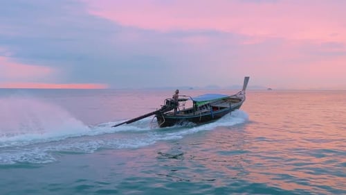 A Serene Sunset Over Krabi Thailand Featuring a Charming LongTail Boat