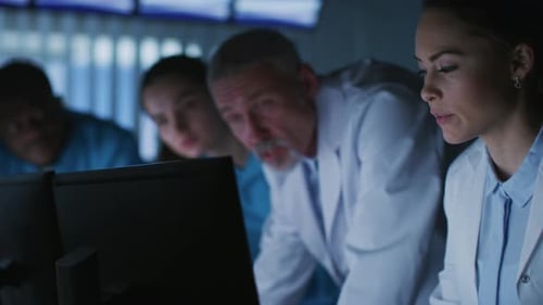 Diverse Group of Medical Scientists Solve Problems and Point at Computer Screens Showing CT, MRI Sc