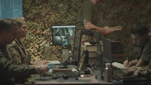 Military Commander Handing Folders with Documents to Office Workers