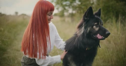 Woman Poses with Dog in Field