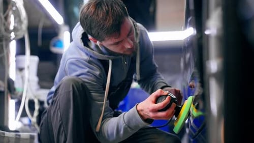 the Car Mechanic at a Service Station Doing the Final Polishing to Shine