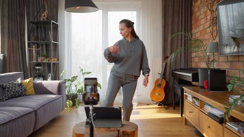 Female influencer recording a trendy dance video for her social media channel