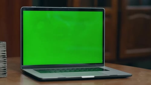 Girl hand presses greenscreen laptop key starting a video lesson at home