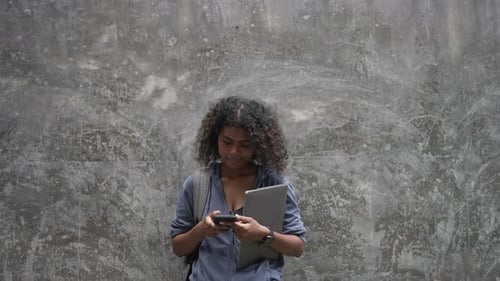 Young Black student woman is living in city.